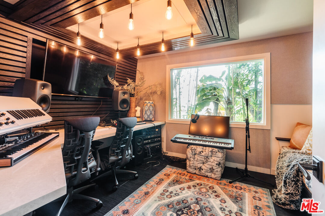 1636 Queens Road Los Angeles, CA 90069 - Photo 12 of 50 a living room with furniture a flat screen tv and a floor to ceiling window