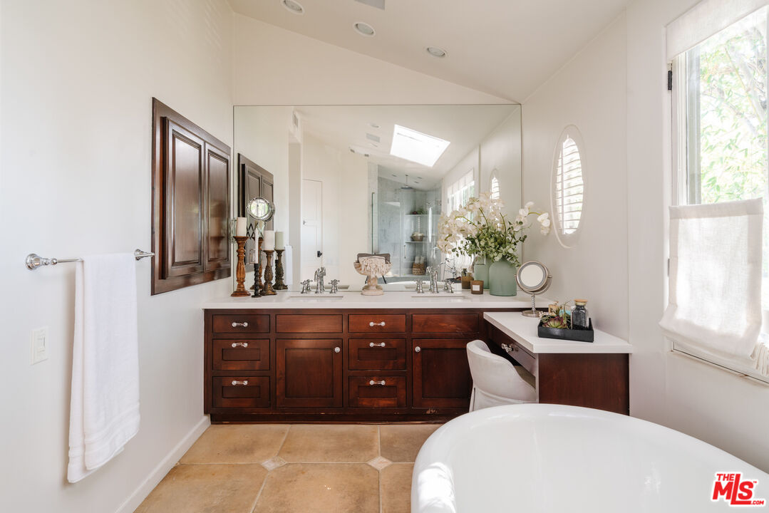 1636 Queens Road Los Angeles, CA 90069 - Photo 23 of 50 a bathroom with a double vanity sink a mirror and a toilet