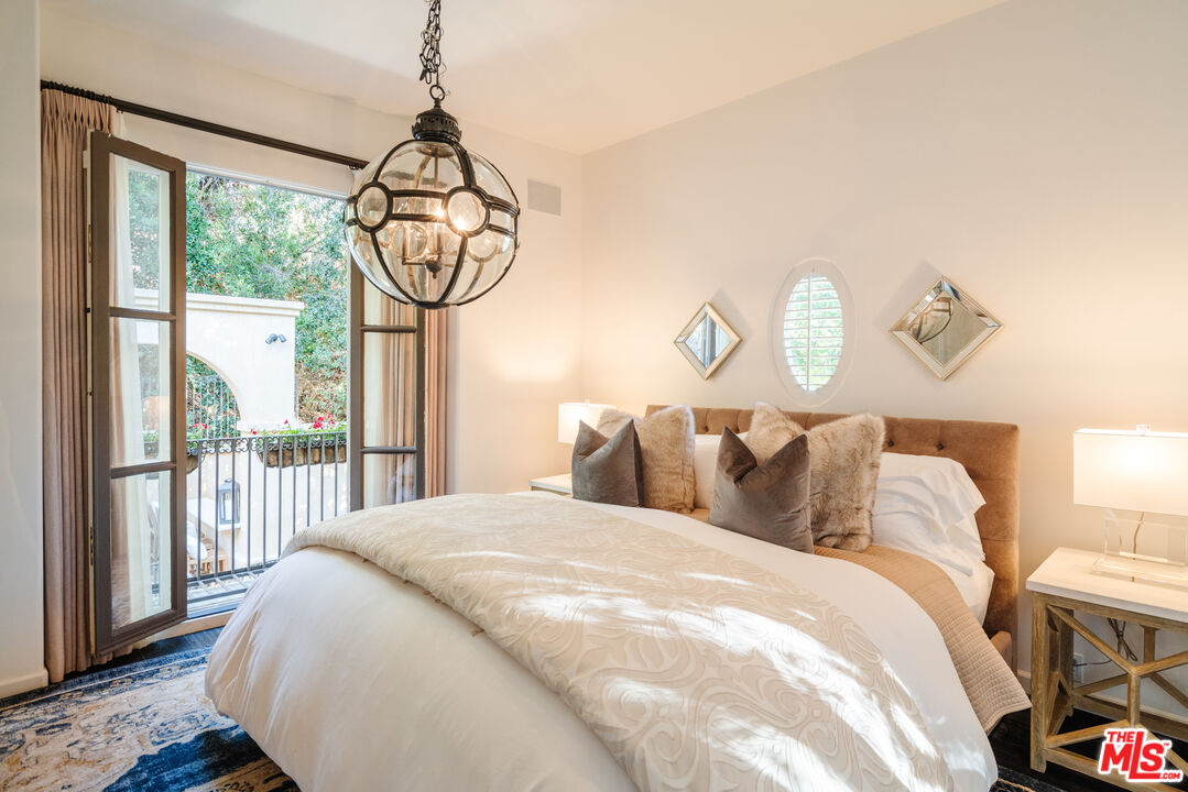 1636 Queens Road Los Angeles, CA 90069 - Photo 30 of 50 a bedroom with a bed a mirror and a window