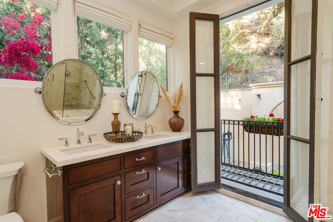 1636 Queens Road Los Angeles, CA 90069 - Photo 34 of 50 a bathroom with a double vanity sink and a mirror