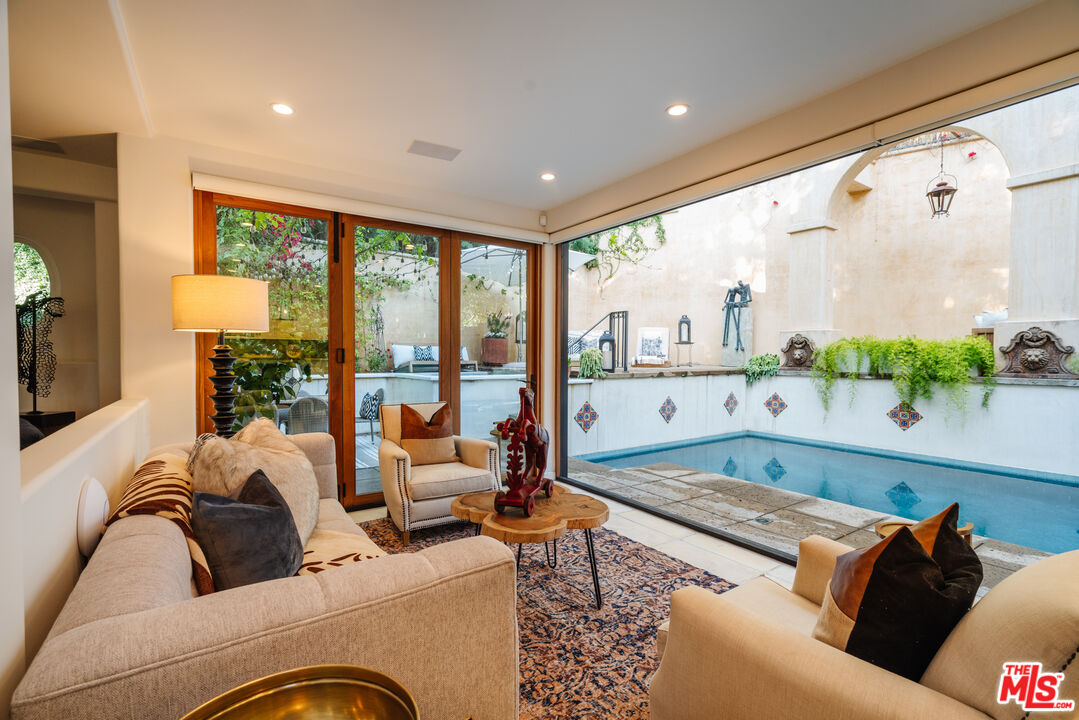1636 Queens Road Los Angeles, CA 90069 - Photo 5 of 50 a living room with furniture and floor to ceiling window