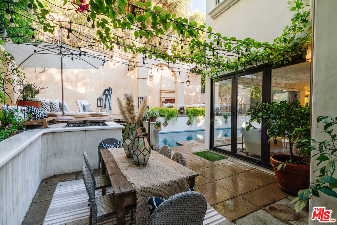 1636 Queens Road Los Angeles, CA 90069 - Photo 41 of 50 a view of a patio with table and chairs under an umbrella