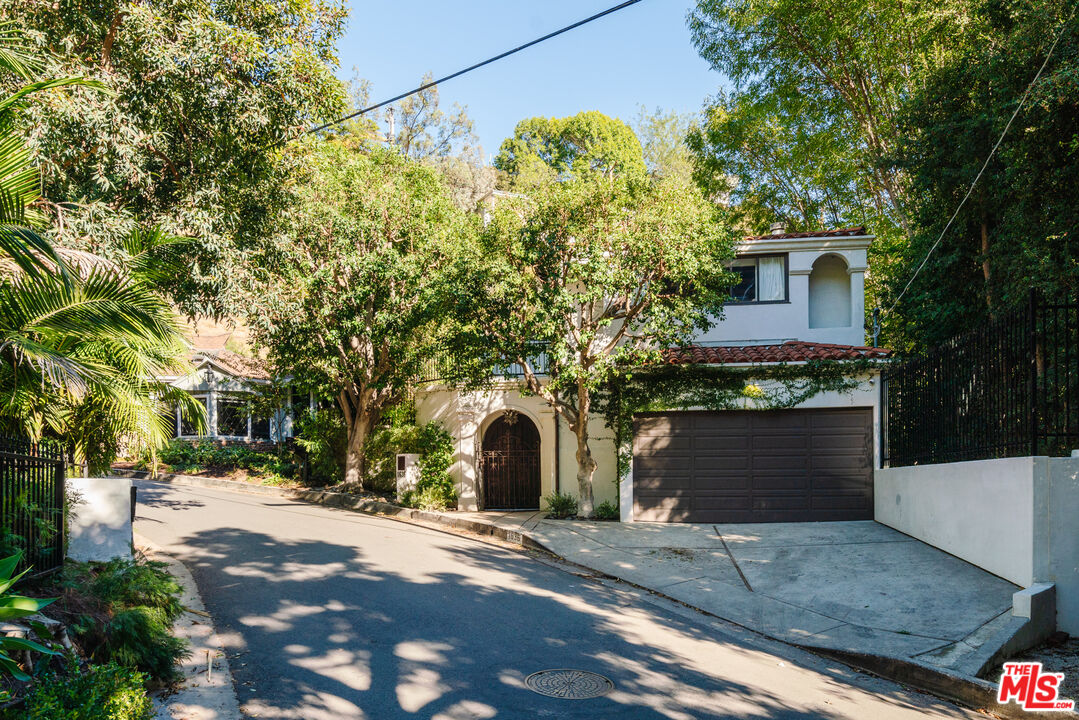 1636 Queens Road Los Angeles, CA 90069 - Photo 49 of 50 a front view of a house with a yard and garage