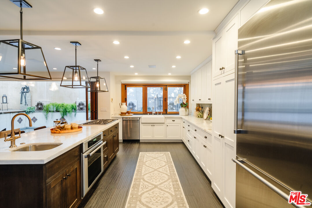 1636 Queens Road Los Angeles, CA 90069 - Photo 6 of 50 a large white kitchen with a large window