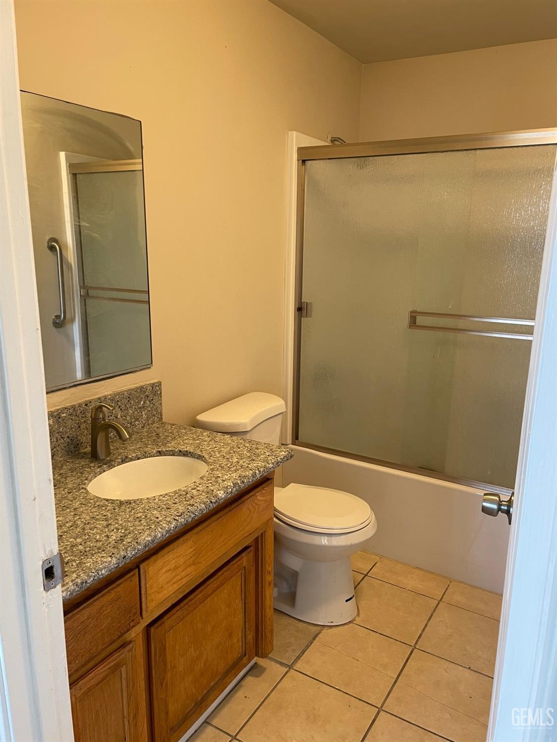 Undisclosed Address Bakersfield, CA 93307 - Photo 15 of 20 a bathroom with a granite countertop sink toilet and shower