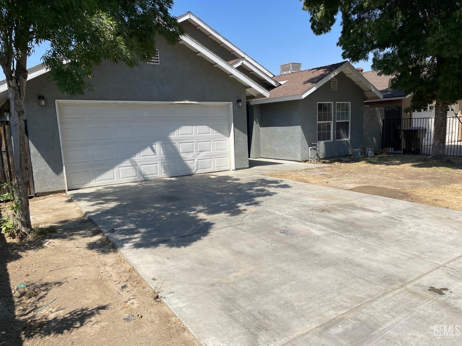 Undisclosed Address Bakersfield, CA 93307 - Photo 3 of 20 a front view of a house with a yard