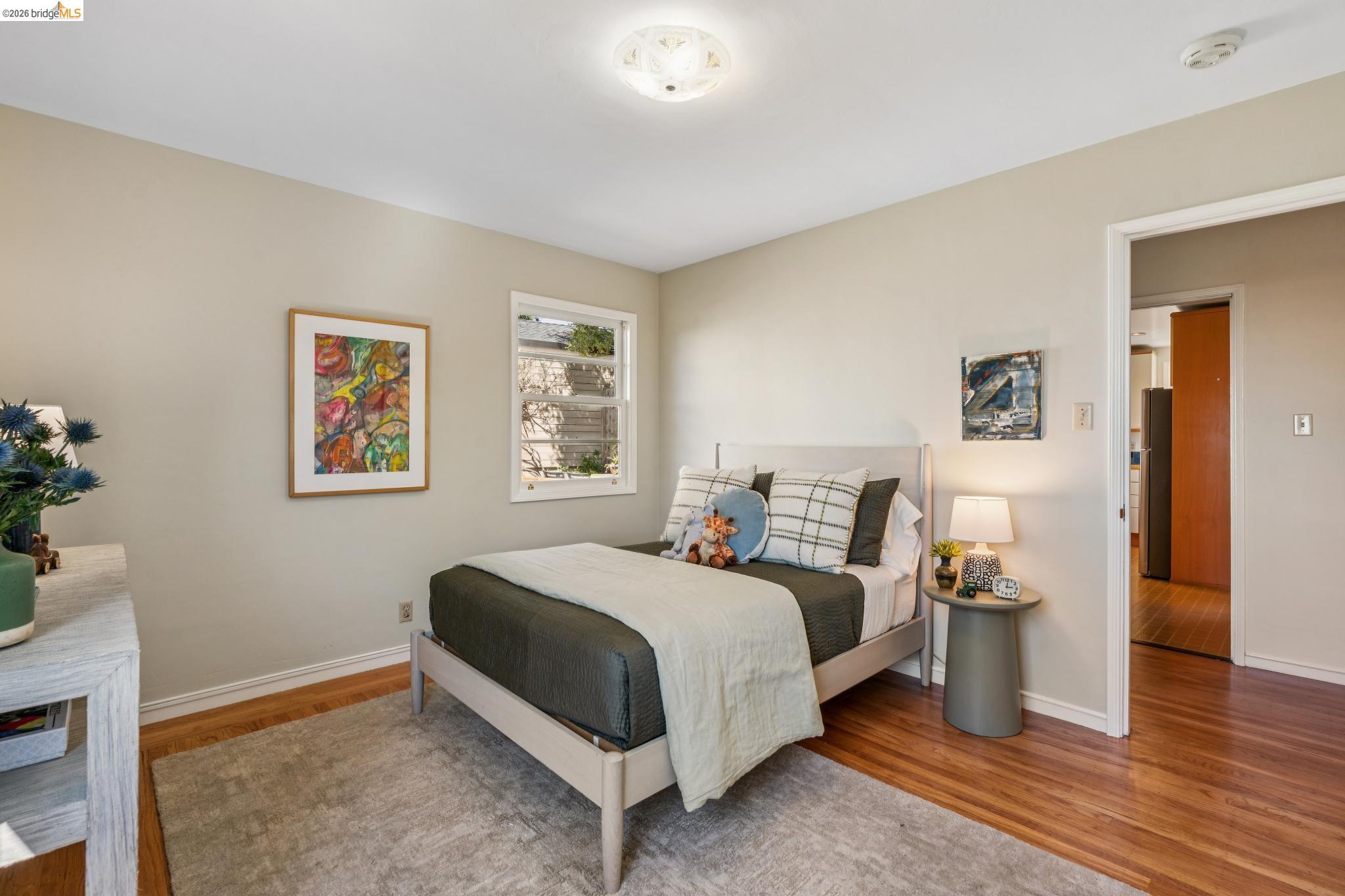 890 Keeler Avenue Berkeley, CA 94708 - Photo 24 of 39 a bedroom with a bed and wooden floor