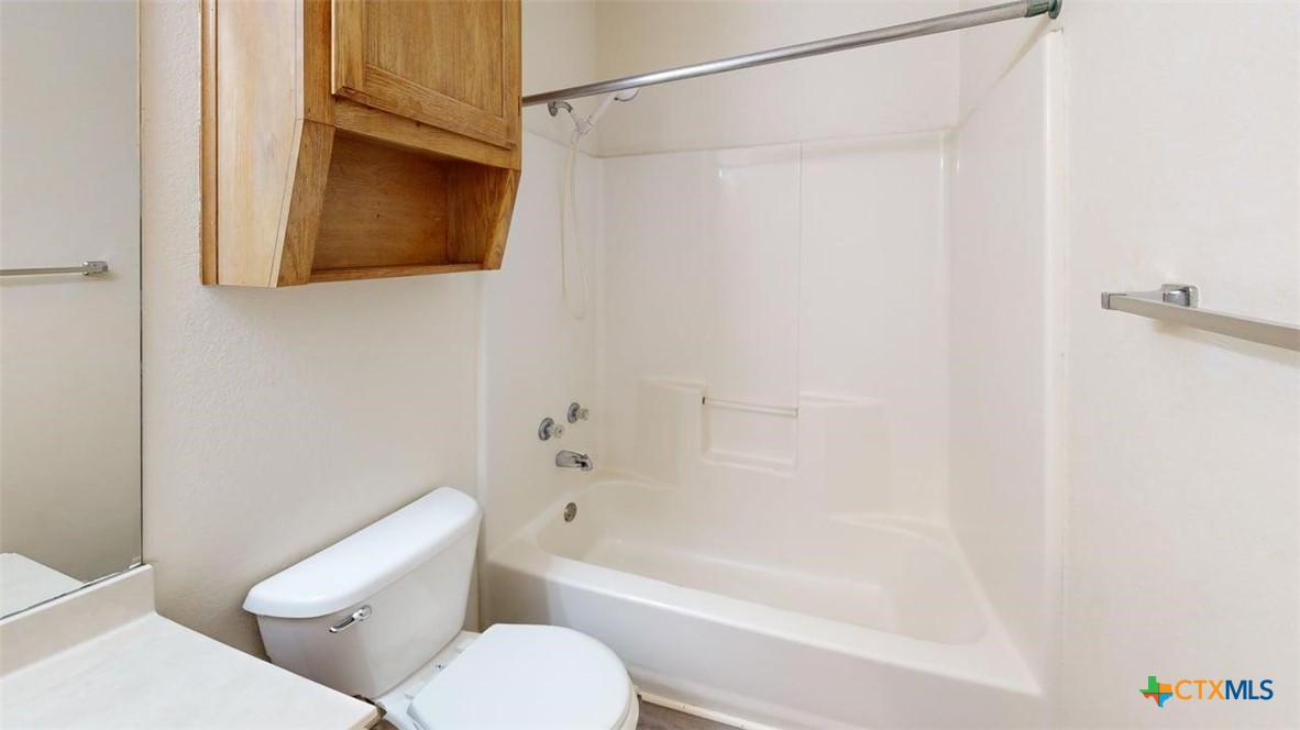 204 West Truman Avenue, Unit D Copperas Cove, TX 76522 - Photo 12 of 12 a bathroom with a toilet and a bathtub