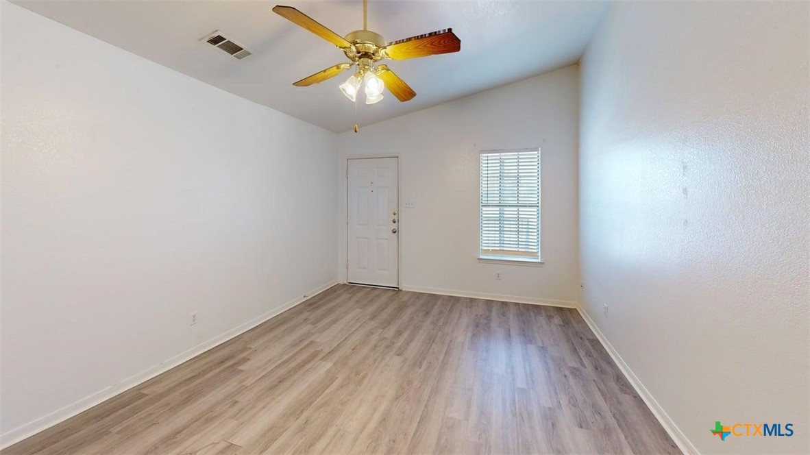 204 West Truman Avenue, Unit D Copperas Cove, TX 76522 - Photo 10 of 12 an empty room with wooden floor and windows