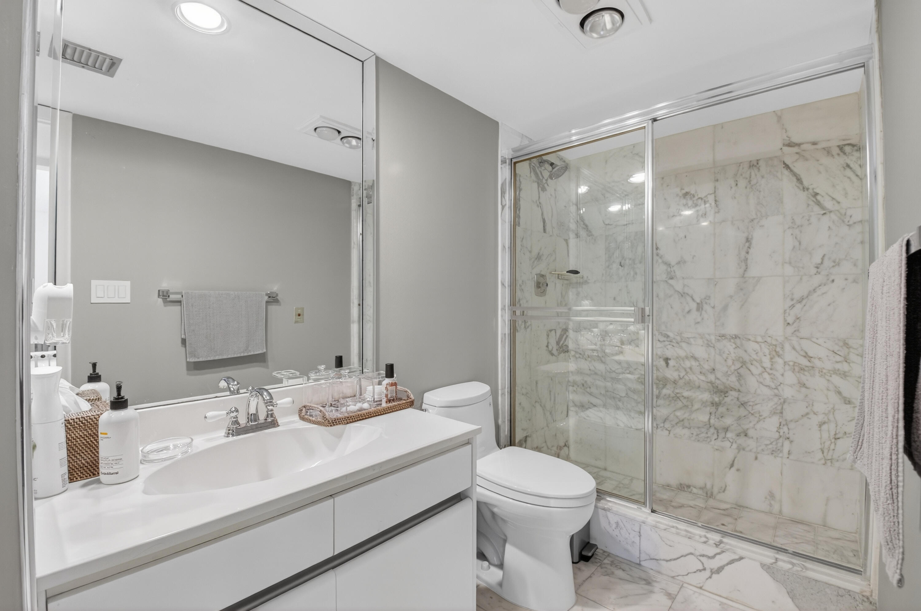 7369 Orangewood Lane, Unit 307 Boca Raton, FL 33433 - Photo 15 of 37 a bathroom with a sink a toilet and shower