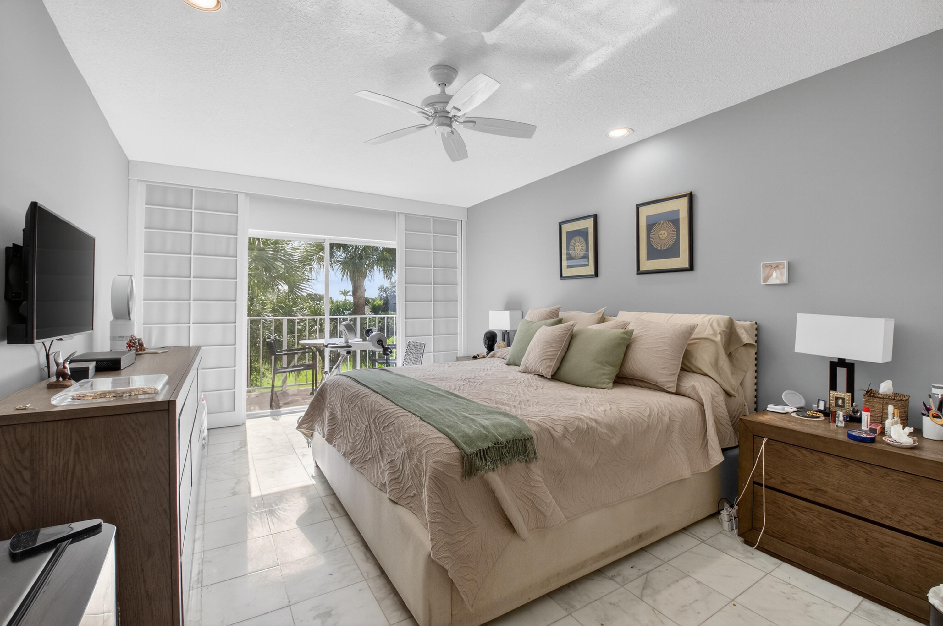 7369 Orangewood Lane, Unit 307 Boca Raton, FL 33433 - Photo 19 of 37 a bedroom with a bed and a flat screen tv