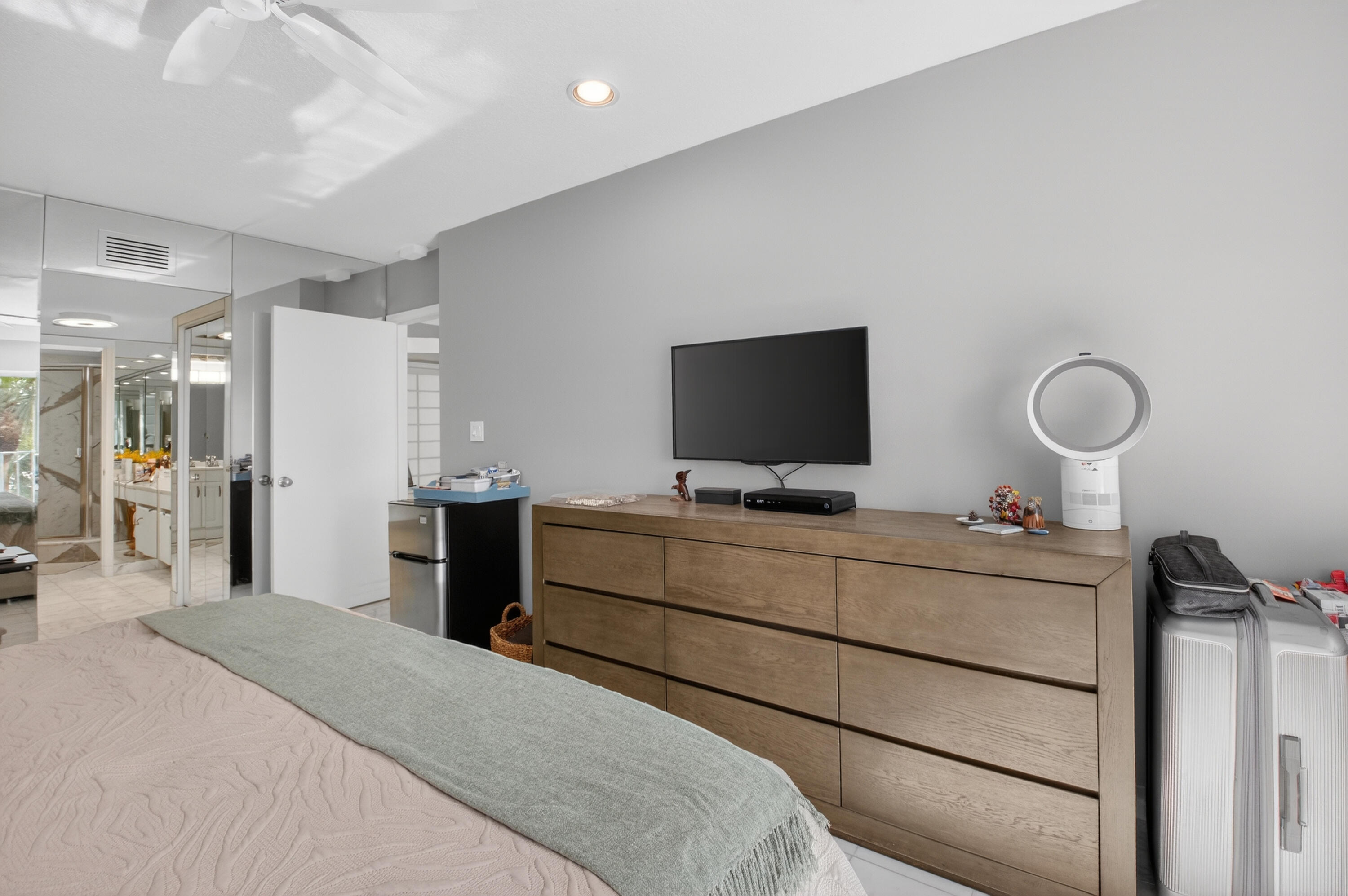 7369 Orangewood Lane, Unit 307 Boca Raton, FL 33433 - Photo 21 of 37 a bedroom with a bed and a flat screen tv