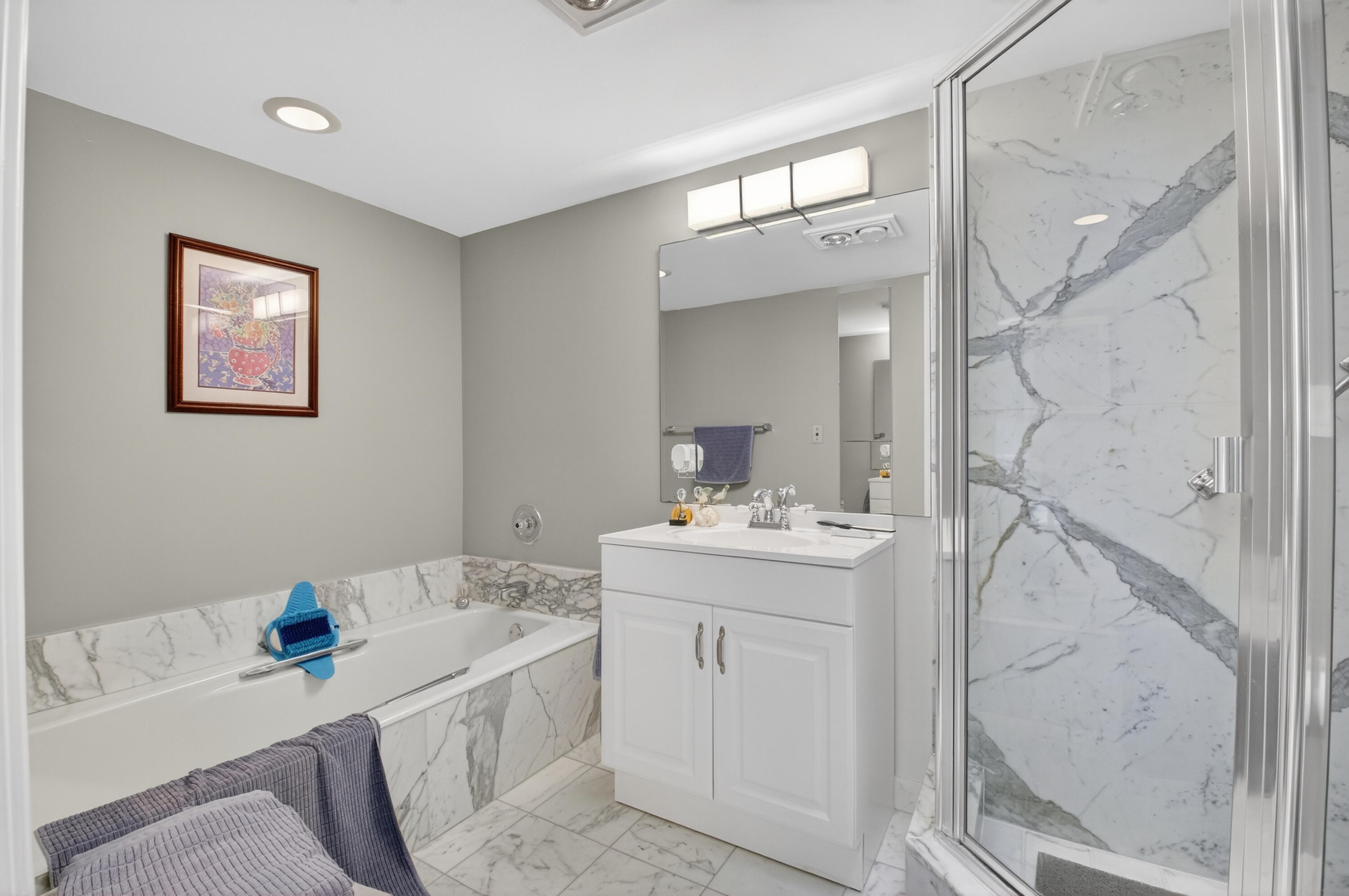 7369 Orangewood Lane, Unit 307 Boca Raton, FL 33433 - Photo 23 of 37 a bathroom with a sink a vanity and a mirror