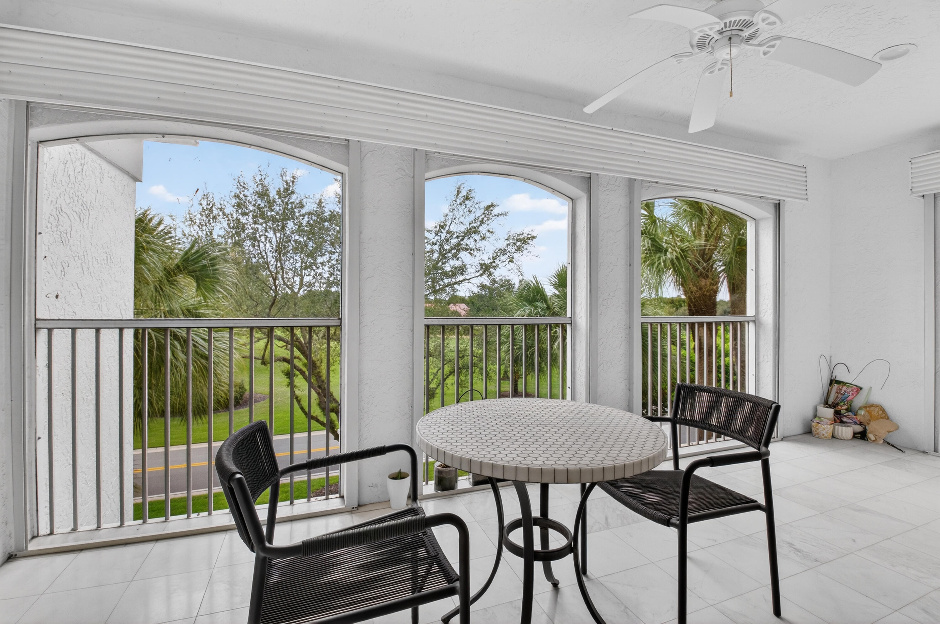 7369 Orangewood Lane, Unit 307 Boca Raton, FL 33433 - Photo 24 of 37 a view of a balcony with furniture and a window