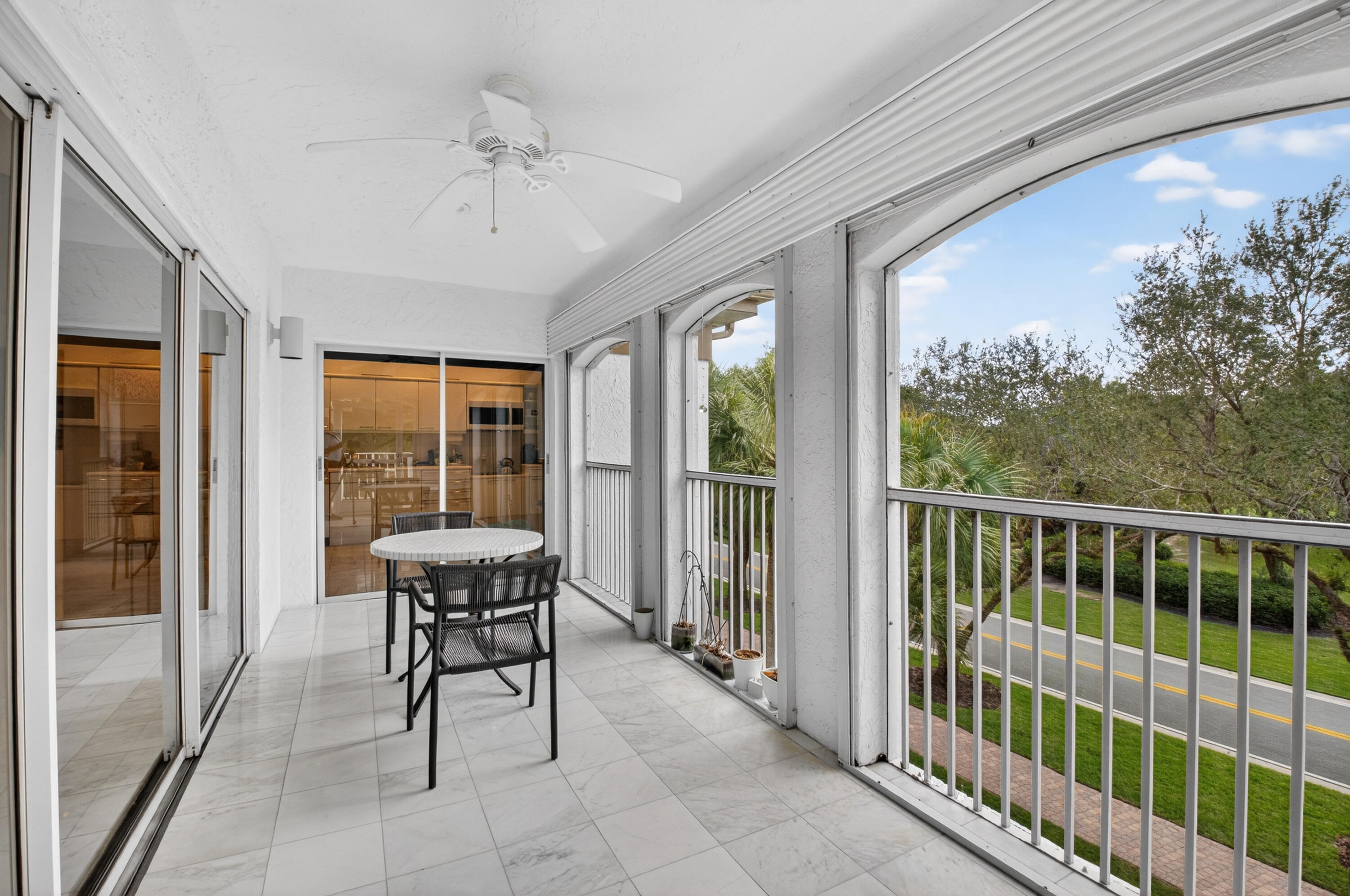 7369 Orangewood Lane, Unit 307 Boca Raton, FL 33433 - Photo 26 of 37 a balcony with furniture and a potted plant