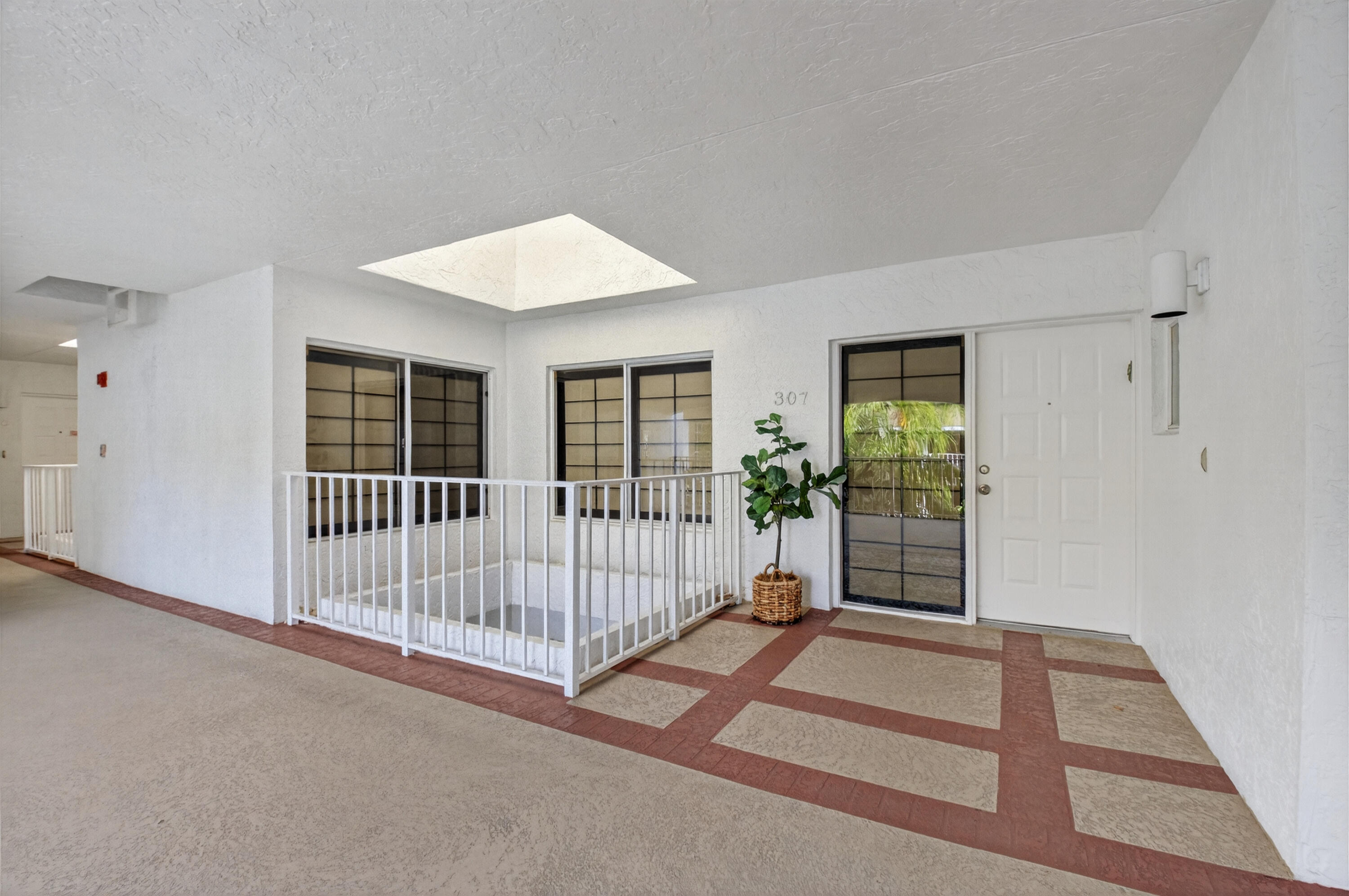 7369 Orangewood Lane, Unit 307 Boca Raton, FL 33433 - Photo 3 of 37 a view of a room with stairs and a ceiling fan