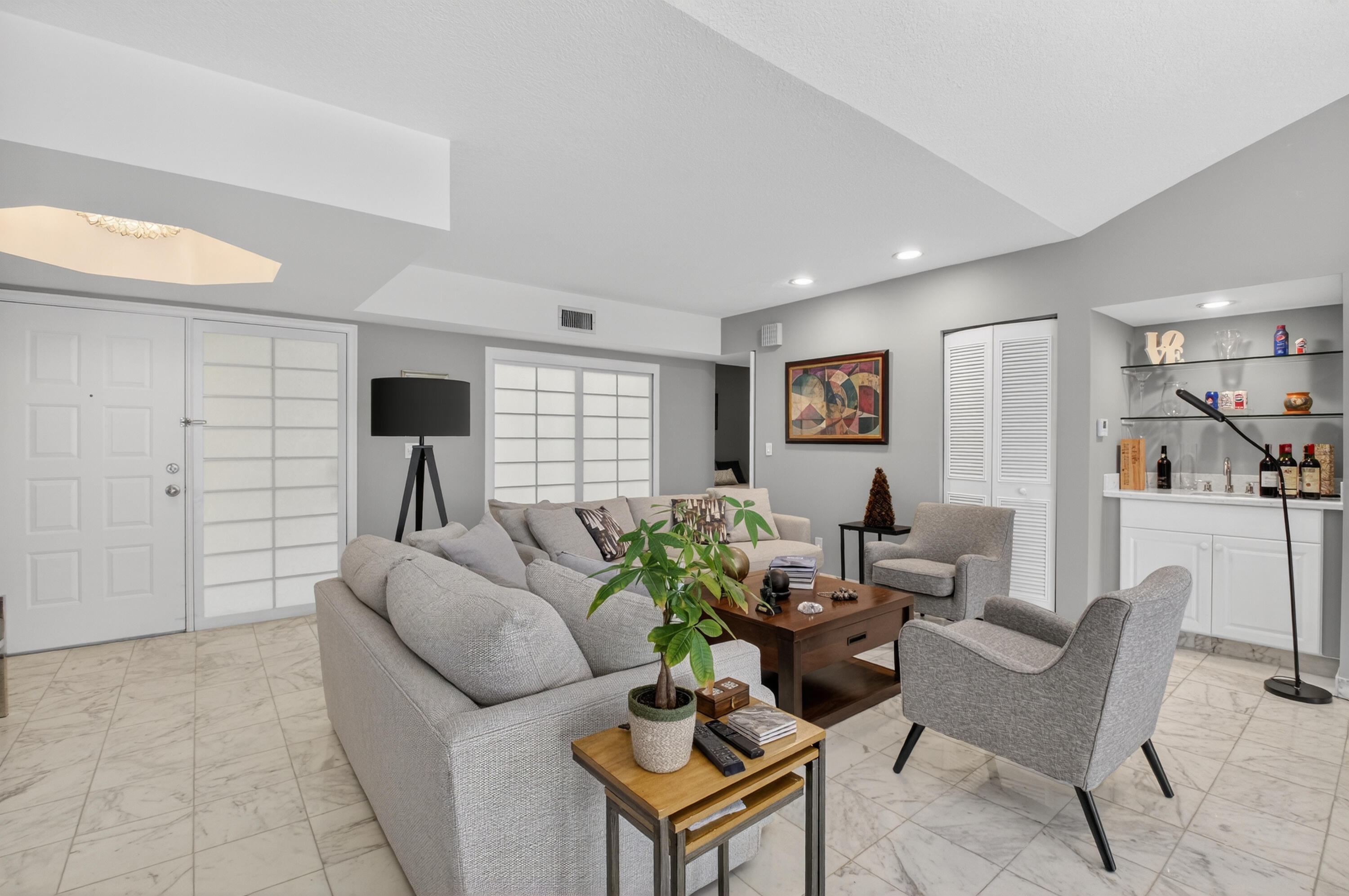 7369 Orangewood Lane, Unit 307 Boca Raton, FL 33433 - Photo 5 of 37 a living room with furniture and a table
