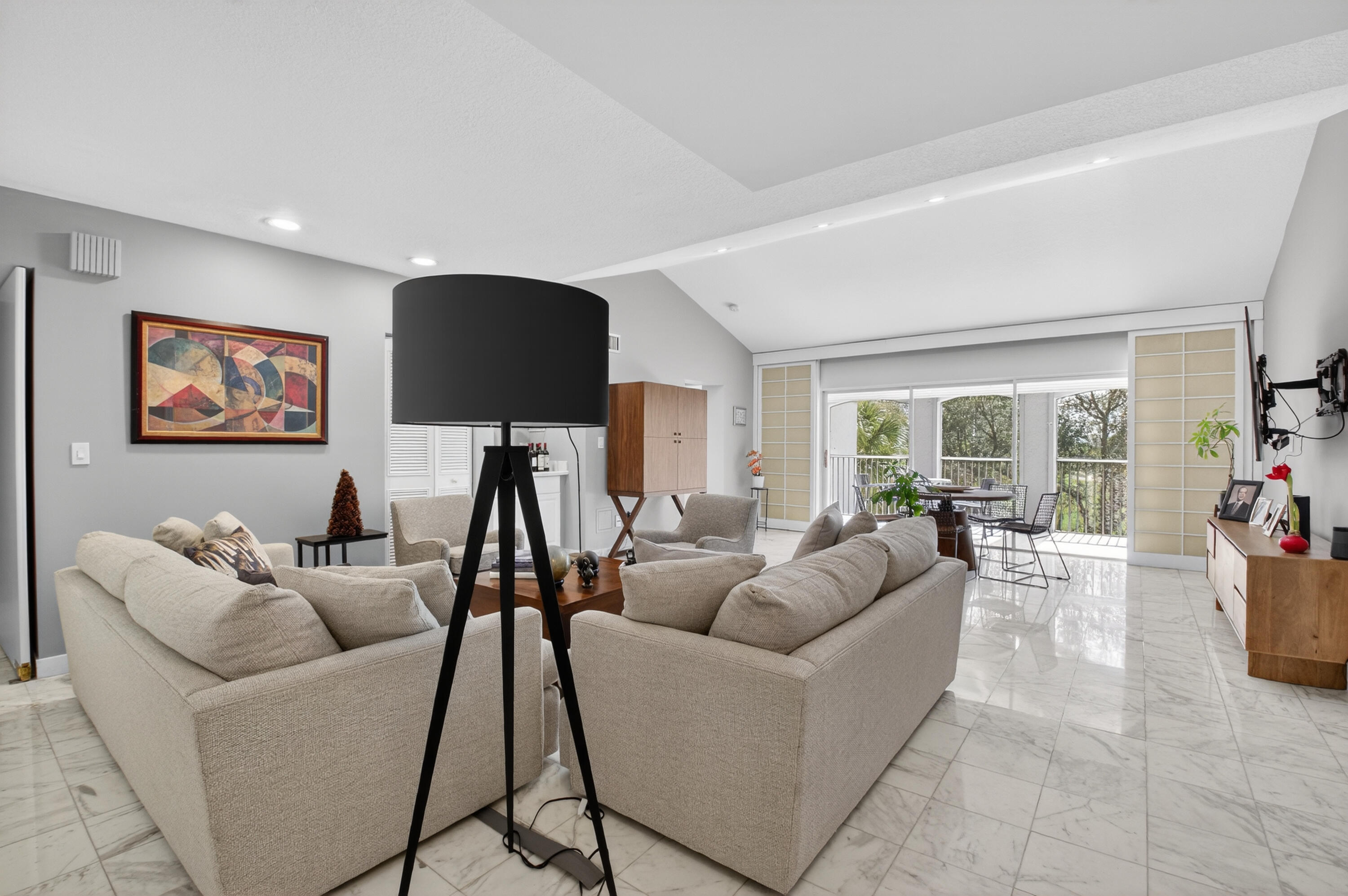 7369 Orangewood Lane, Unit 307 Boca Raton, FL 33433 - Photo 6 of 37 a living room with furniture and a flat screen tv