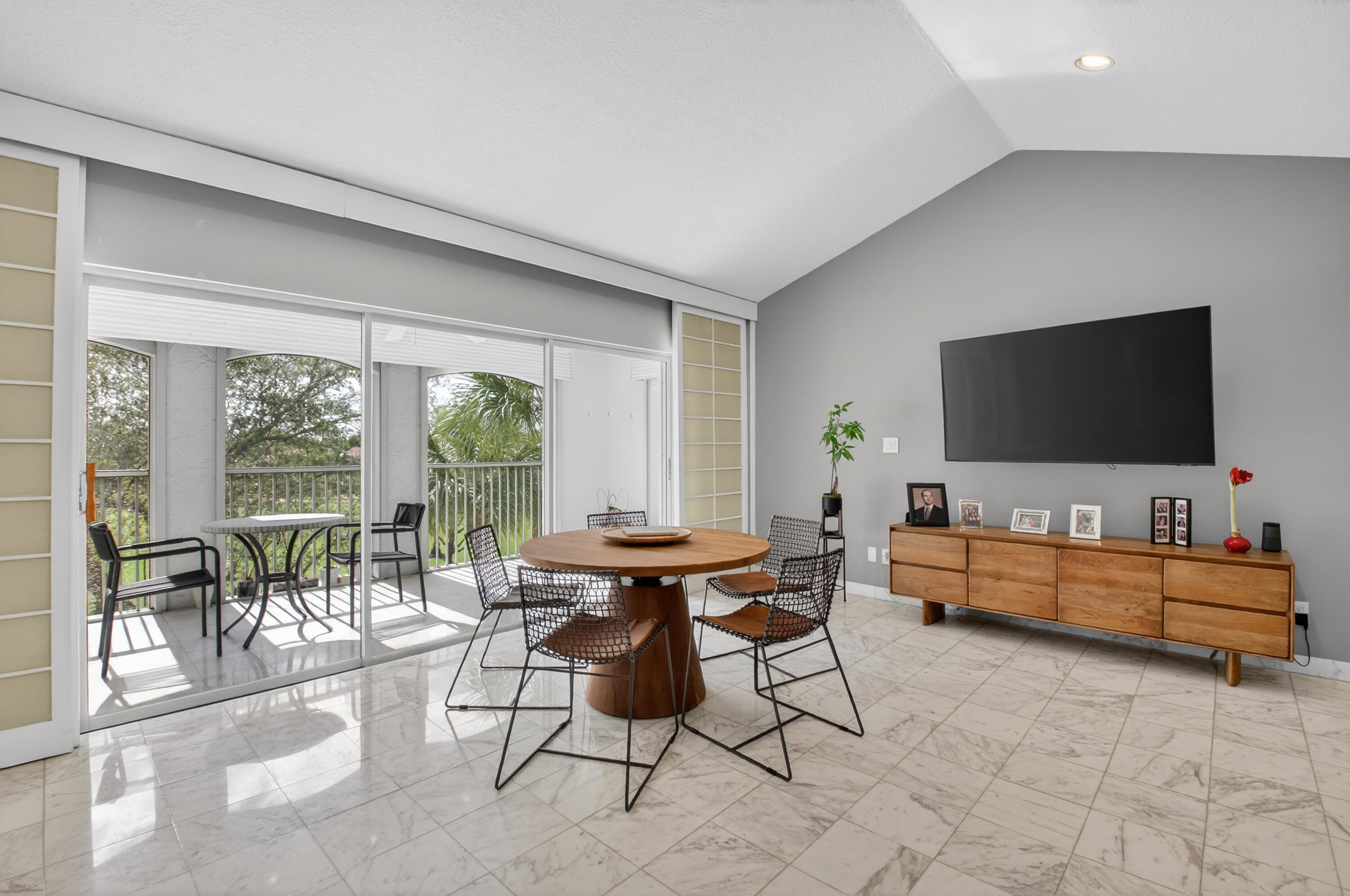 7369 Orangewood Lane, Unit 307 Boca Raton, FL 33433 - Photo 8 of 37 a living room with furniture and a flat screen tv