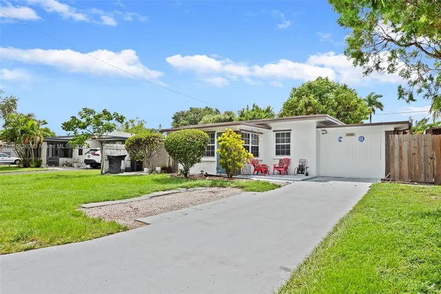 a front view of a house with a yard and a garage
