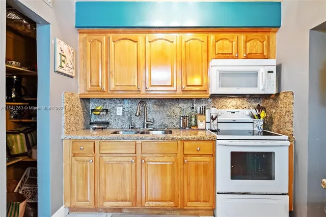 a kitchen with stainless steel appliances granite countertop a stove and a refrigerator