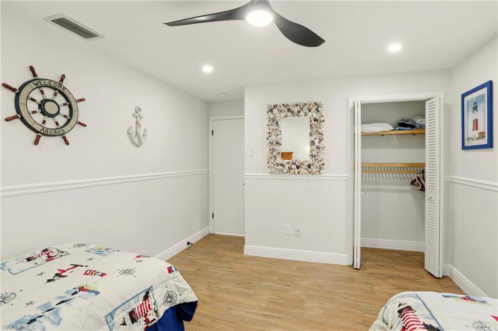 339 Landmark Street Marco Island, FL 34145 - Photo 25 of 50 Bedroom featuring light wood-type flooring, a closet, ceiling fan, and recessed lighting