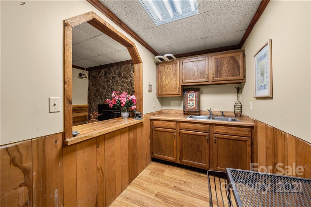 1595 Kitchens Branch Road Sylva, NC 28779 - Photo 31 of 45 a kitchen with stainless steel appliances granite countertop a sink and wooden cabinets
