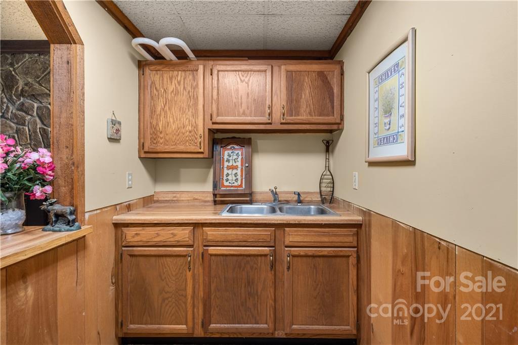 1595 Kitchens Branch Road Sylva, NC 28779 - Photo 32 of 45 a kitchen with stainless steel appliances granite countertop a sink and cabinets