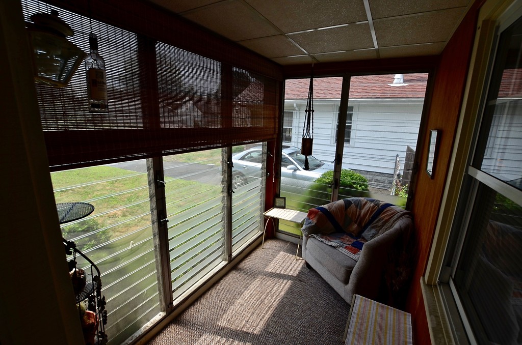 99 Merrimac Avenue Springfield, MA 01104 - Photo 3 of 23 a balcony with wooden floor