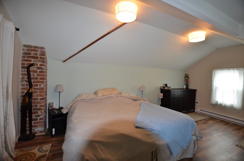 99 Merrimac Avenue Springfield, MA 01104 - Photo 9 of 23 a bedroom with a bed and a window