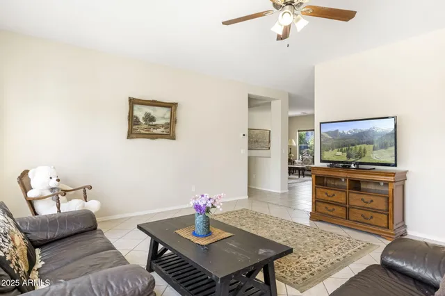 a living room with furniture and view of kitchen