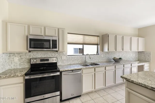 a view of a dining room and kitchen with a large window