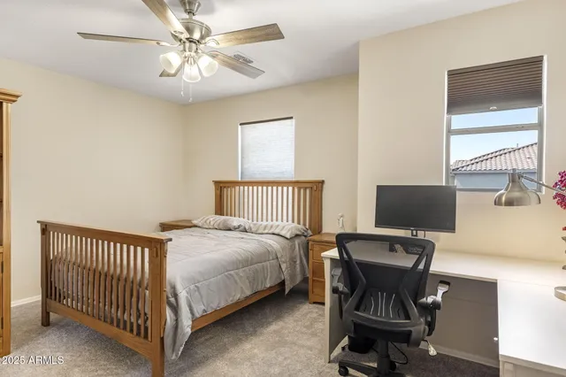 a bedroom with a bed and a desk