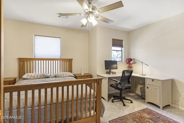 a bedroom with a bed lamp and window