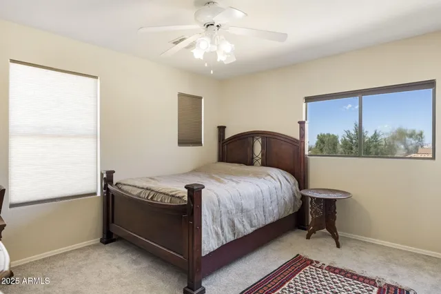 a bedroom with a bed and a mirror on dresser