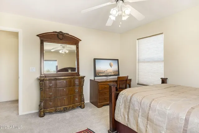 a bed sitting in a room next to a window