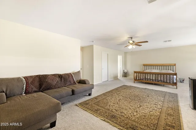a bathroom with a granite countertop sink a large mirror and a shower