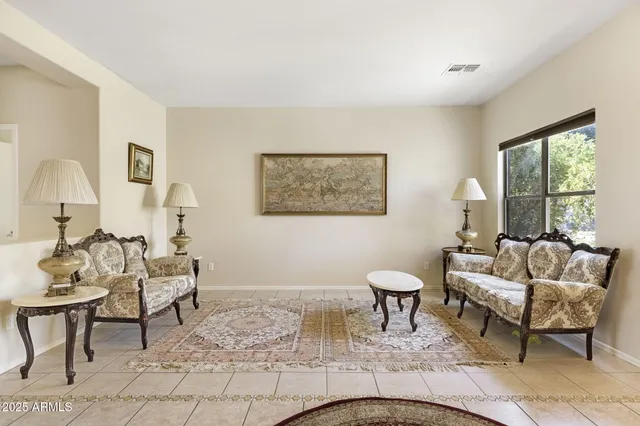 a living room with furniture a table and a large window