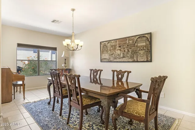 a view of a dining room with furniture and chandelier