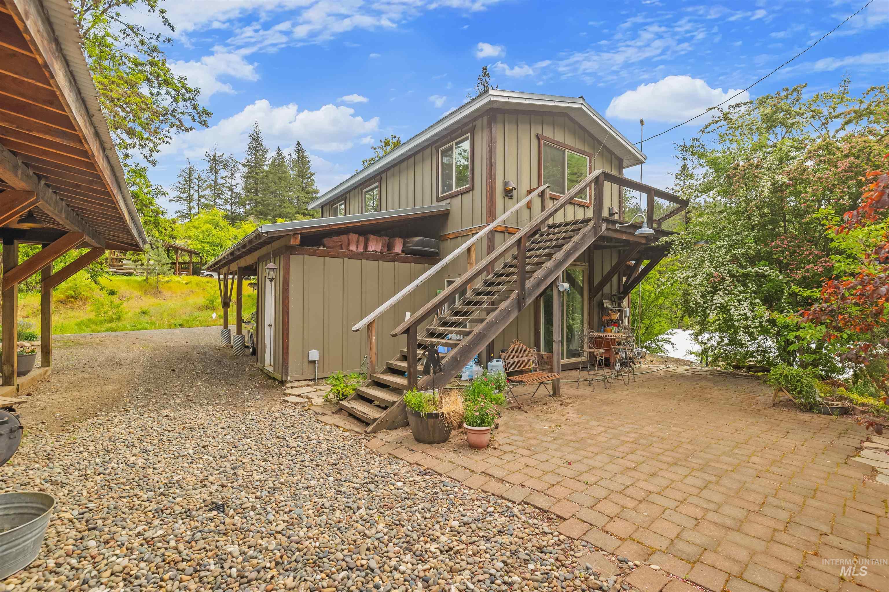 1314 Cedar Ridge Road Kendrick, ID 83537 - Photo 32 of 50 Vertical siding exterior with an exterior staircase leading to a second-story balcony