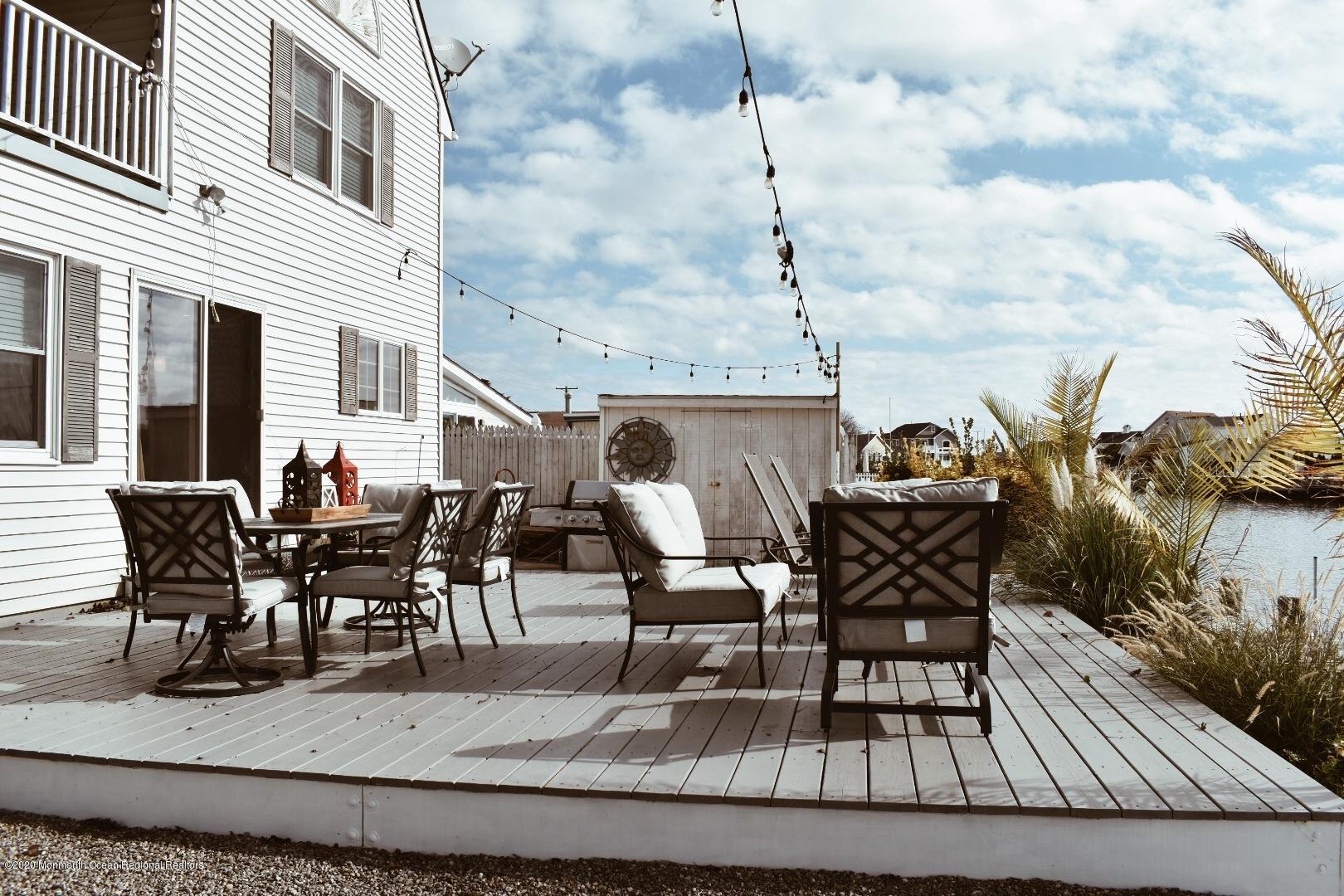 30 Amherst Drive Bayville, NJ 08721 - Photo 6 of 9 a view of a roof deck with table and chairs
