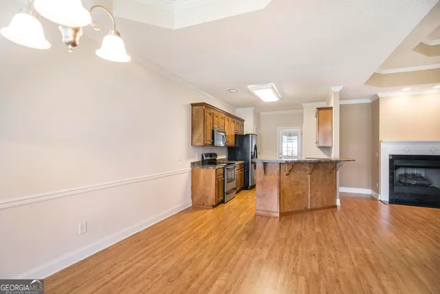 a kitchen with stainless steel appliances granite countertop a stove a sink and a microwave