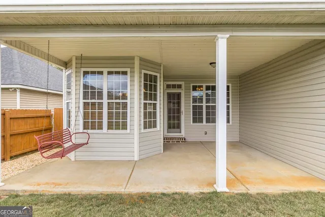 a view of a house with wooden fence