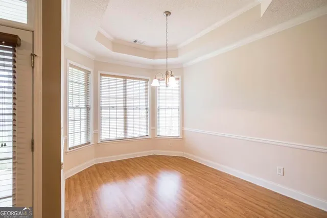 a kitchen with stainless steel appliances granite countertop a refrigerator a stove top oven a sink dishwasher and wooden floor