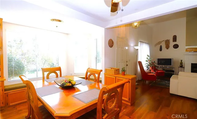 a living room with furniture a fireplace and a floor to ceiling window
