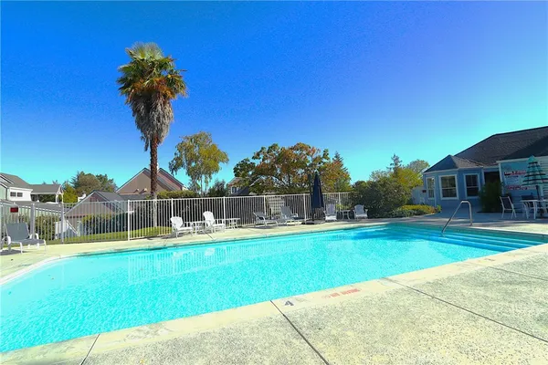 a view of a swimming pool with a table and chairs