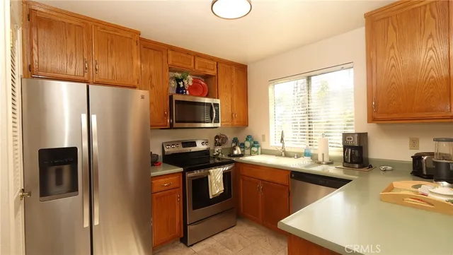 a kitchen with a sink stove and window