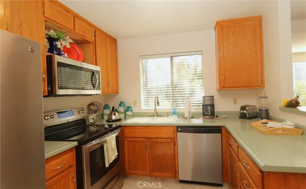 a kitchen with stainless steel appliances granite countertop a refrigerator and a stove