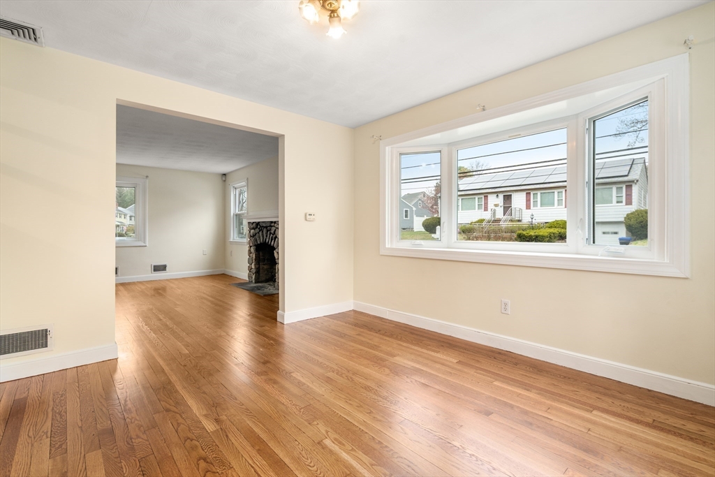 125 Lyman Road Milton, MA 02186 - Photo 11 of 25 a view of empty room with wooden floor and fan