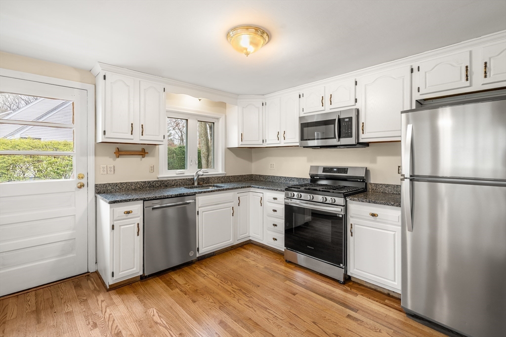 125 Lyman Road Milton, MA 02186 - Photo 12 of 25 a kitchen with granite countertop a refrigerator stove top oven and sink